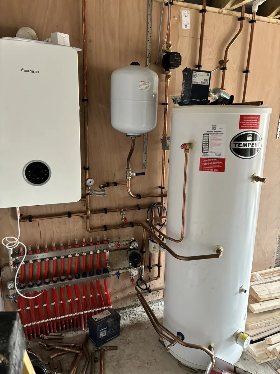 Worcester boiler and Tempest unvented cylinder alongside a labelled underfloor heating manifold, expansion vessel and copper pipework
