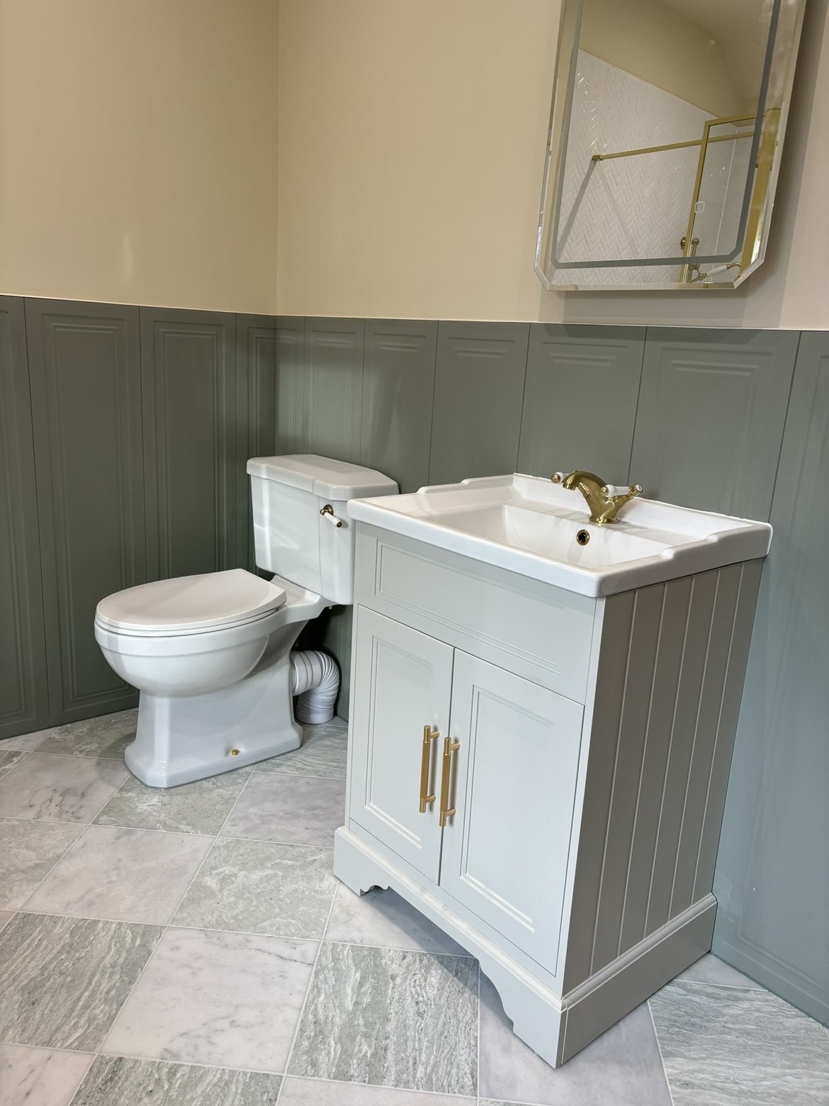 Traditional close-coupled WC and vanity unit with ceramic basin, brass tap and LED mirror above